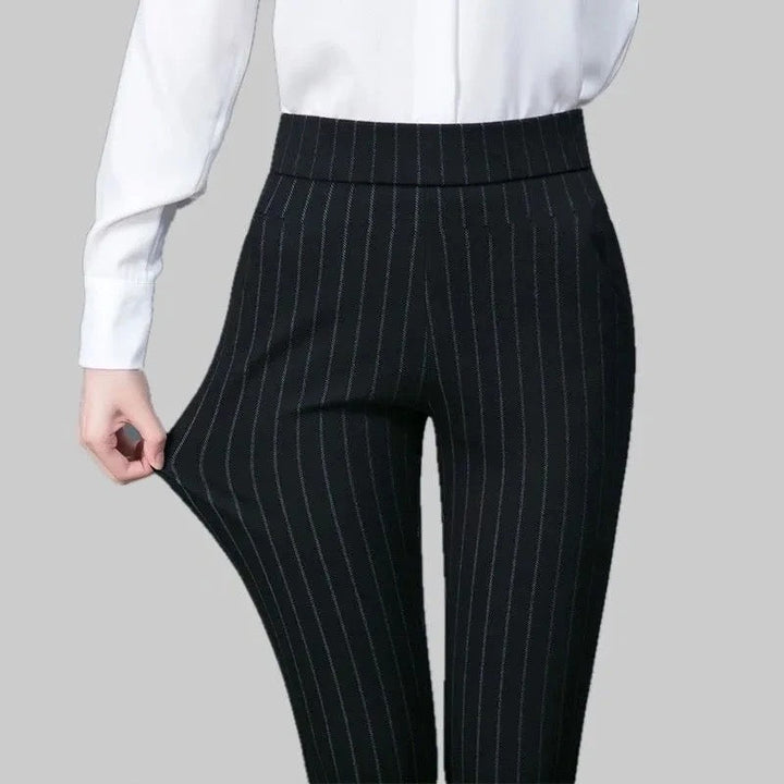 Woman in black stretchy athleisure pants, perfect for everyday comfort & flexible movement. Ideal for casual wear.