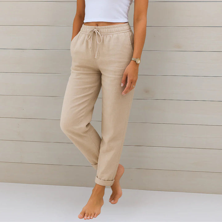 Woman wearing comfortable linen blend stretch trousers in a casual chic style, perfect for summer wear.