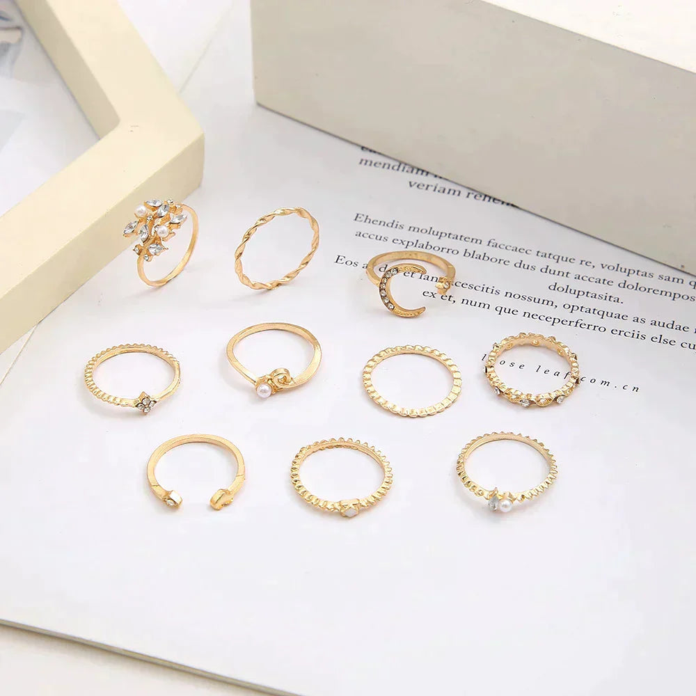 Close-up of women's 10-pair gold & silver boho ring set. Stackable fashion jewelry, versatile for any look.