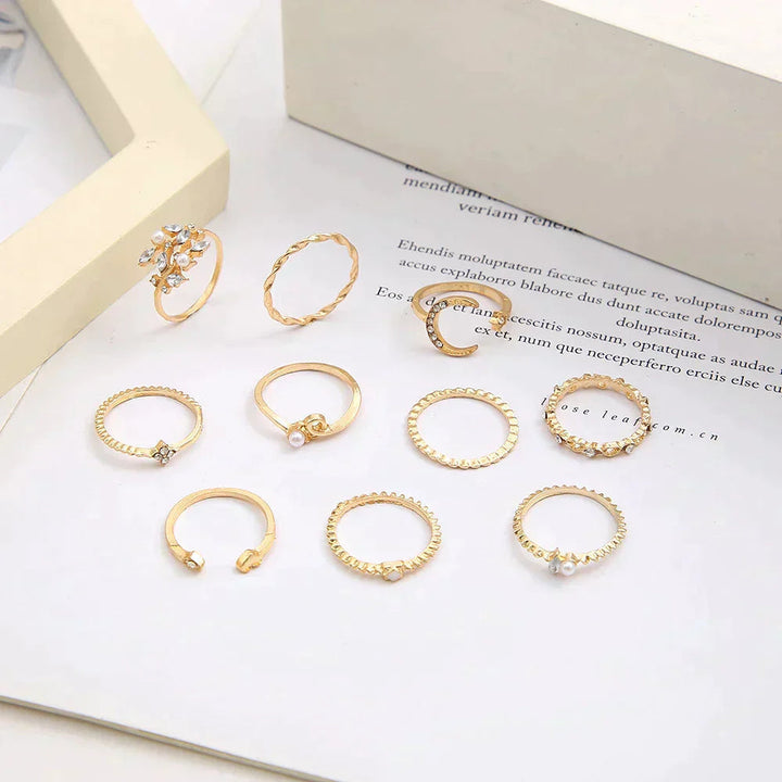 Close-up of women's 10-pair gold & silver boho ring set. Stackable fashion jewelry, versatile for any look.