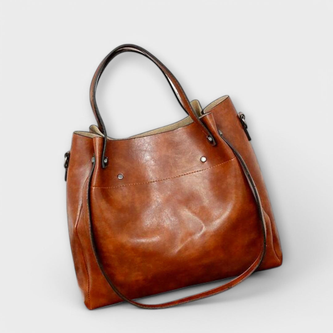 Close-up of a vintage-style women's clutch bag from the 4-piece faux leather set