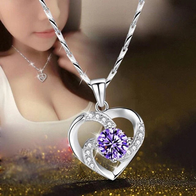 Close-up of rhodium-plated sterling silver heart pendant necklace with shimmering cubic zirconia crystals.