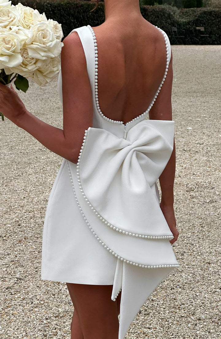 Versatile A-line mini dress with pearl trim, ideal for wedding guests, cocktail parties & formal events.