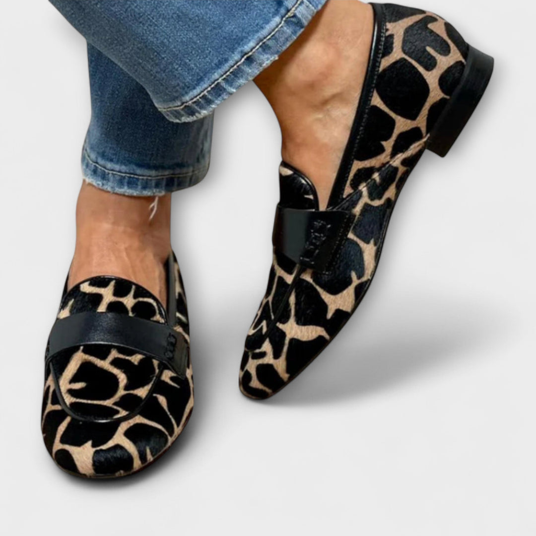 Stylish women's slip-on loafers in a distinctive animal print, perfect for everyday wear