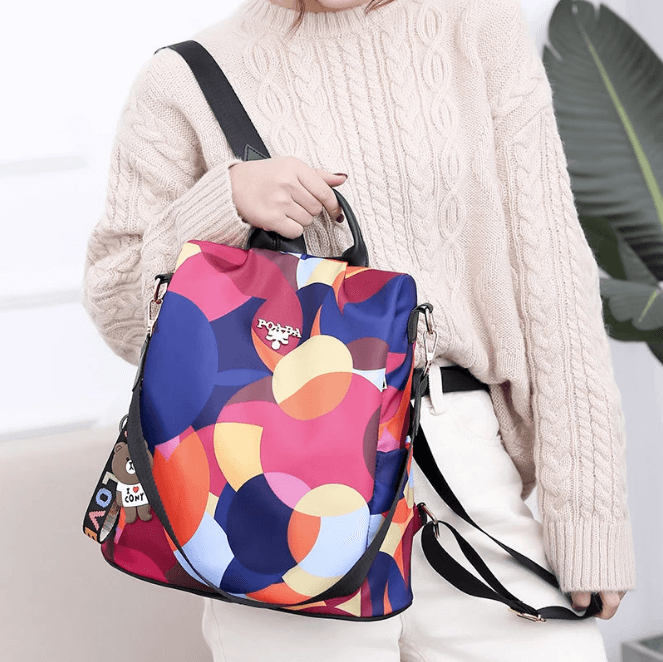 Front view: women's anti-theft backpack, water-resistant, sleek PU leather, secure design & pockets.