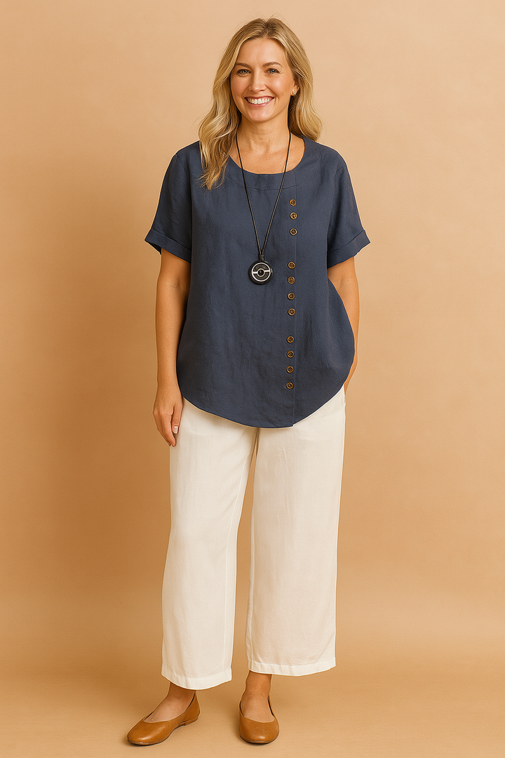 Elegant women's short sleeve shirt with unique asymmetrical design and functional button placket.