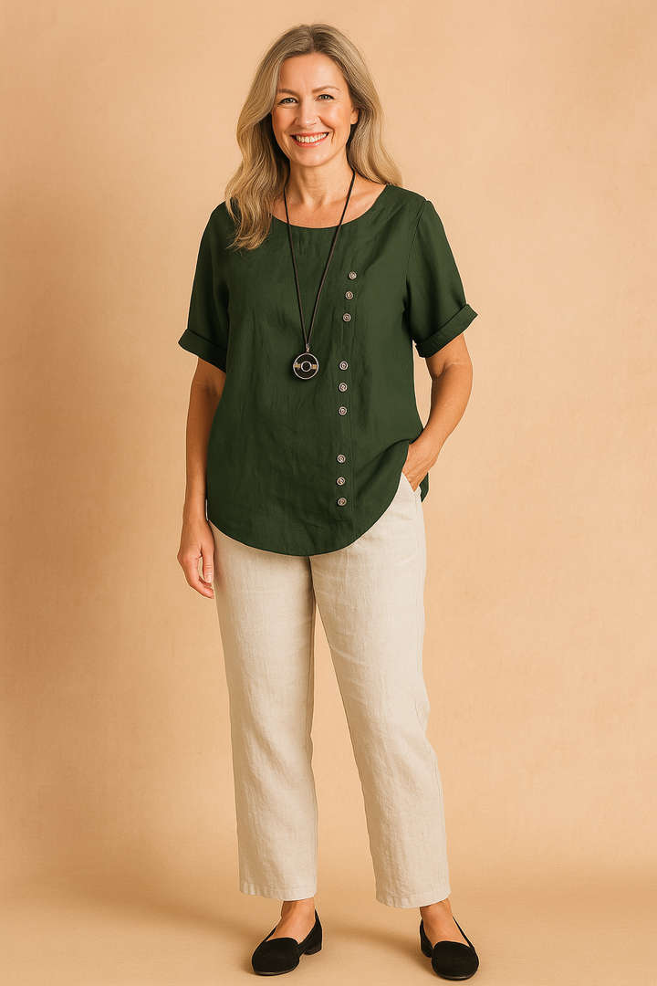 Contemporary women's blouse, asymmetrical and short-sleeved, featuring chic buttons for a modern outfit.