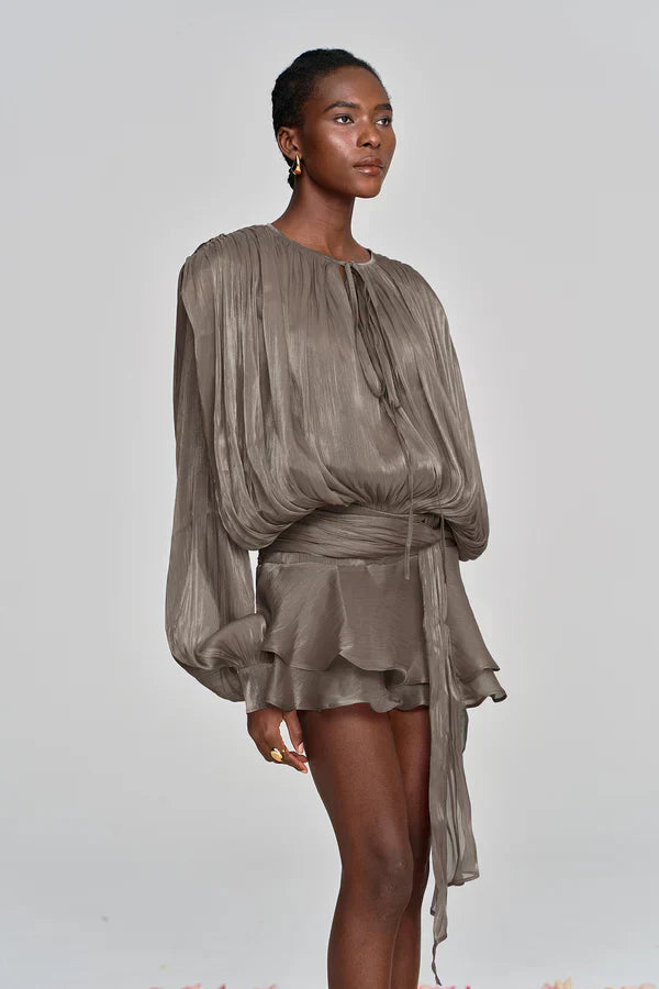 Zoomed-in view of the ruffled neckline and balloon sleeves of a women's stylish mini cocktail dress
