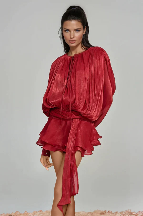 Back view of a women's mini cocktail dress with playful ruffles and chic balloon sleeves, spring fashion