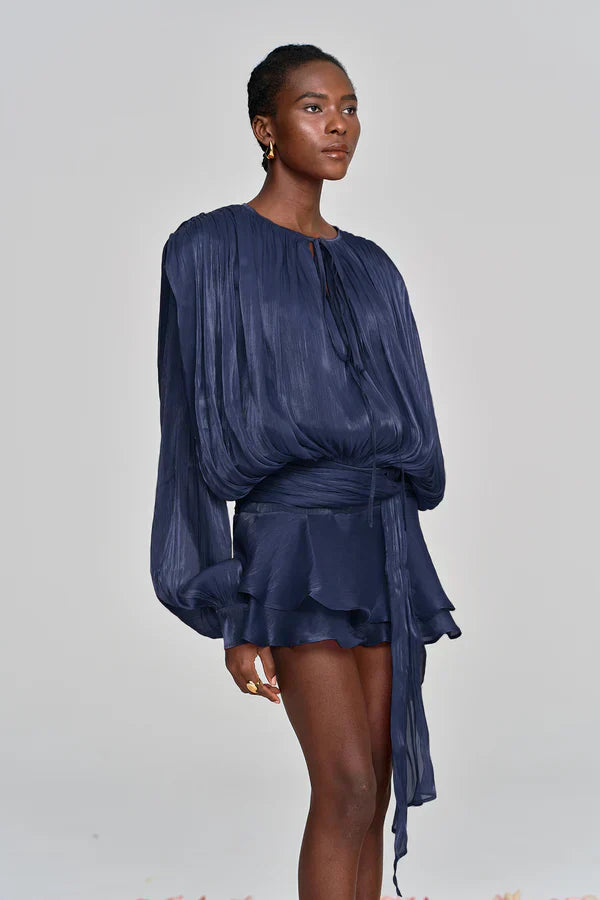 Front shot of a fashionable women's summer dress, a ruffle mini with statement balloon sleeves