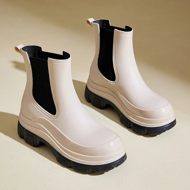 Women's beige chunky sole slip-on ankle boots, stylish and comfortable winter footwear.