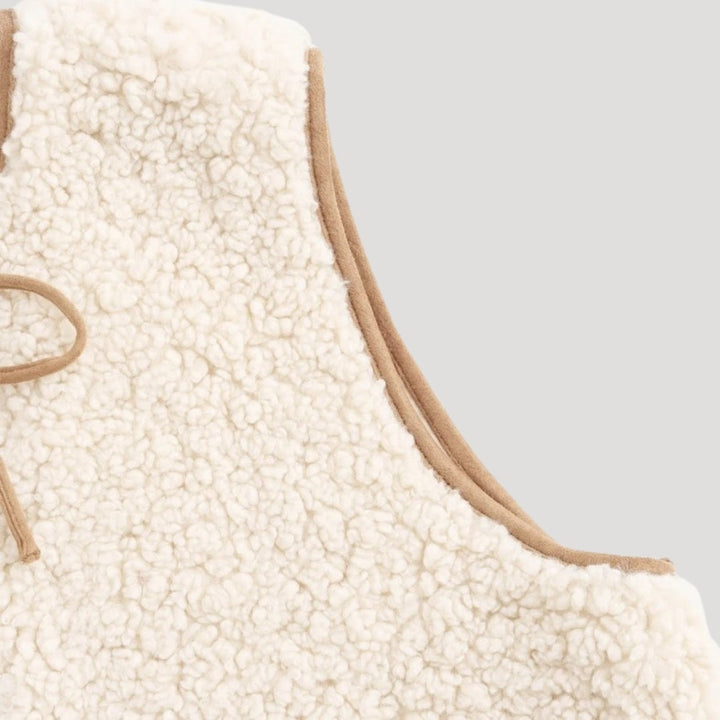 Full shot of a model wearing a women's cozy beige vest with a tie-front, suitable for spring fashion