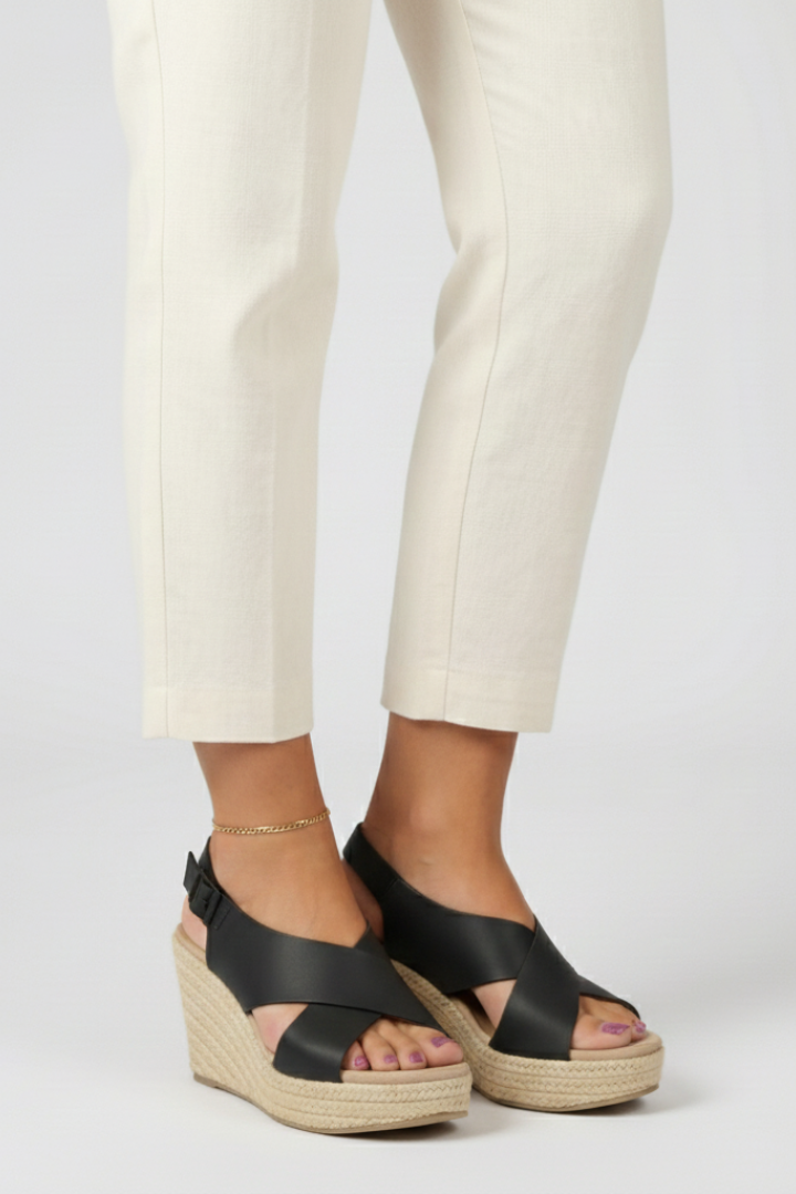 Close-up of brown women's wedge crossover slingback sandals with open toe design