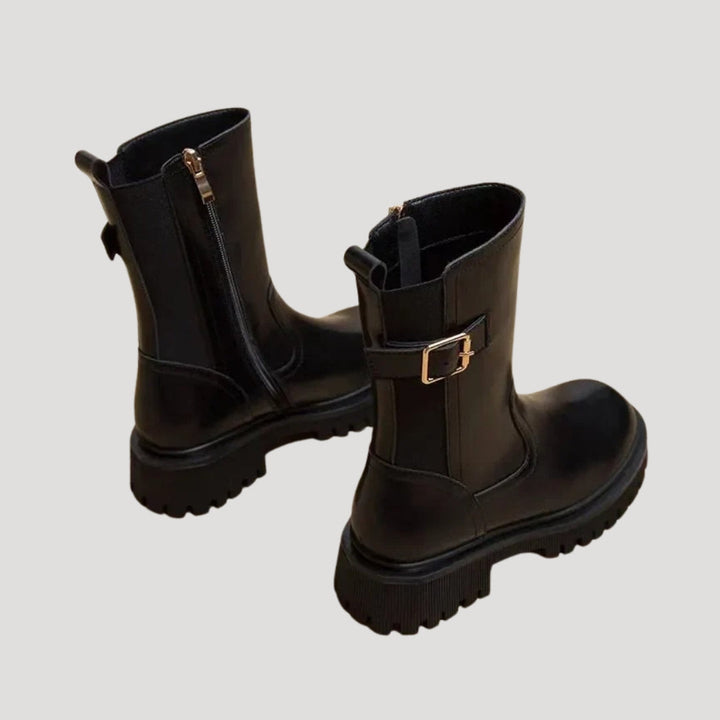 Pair of black chunky mid-calf boots for women, a trending spring footwear choice.