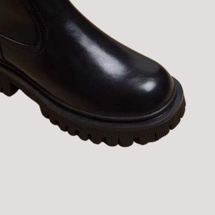 Fashionable women's mid-calf boots with chunky sole, versatile for spring styling.