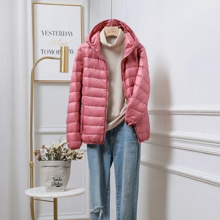 Stylish women's hooded puffer jacket in red, featuring a zip-up front, ideal winter coat