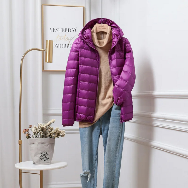 Women's yellow hooded puffer jacket with visible zipper, lightweight and warm for winter