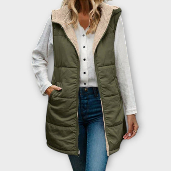 Women's black insulated puffer vest with soft fleece lining, ideal for winter layering and warmth.