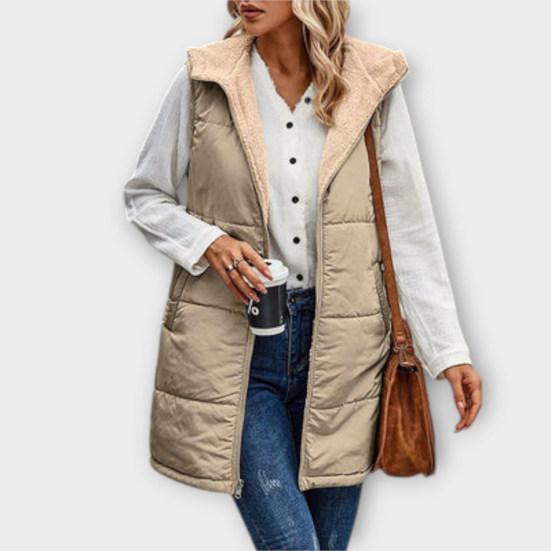 Stylish women's grey puffer gilet featuring a cozy fleece lining, perfect for outdoor casual wear.
