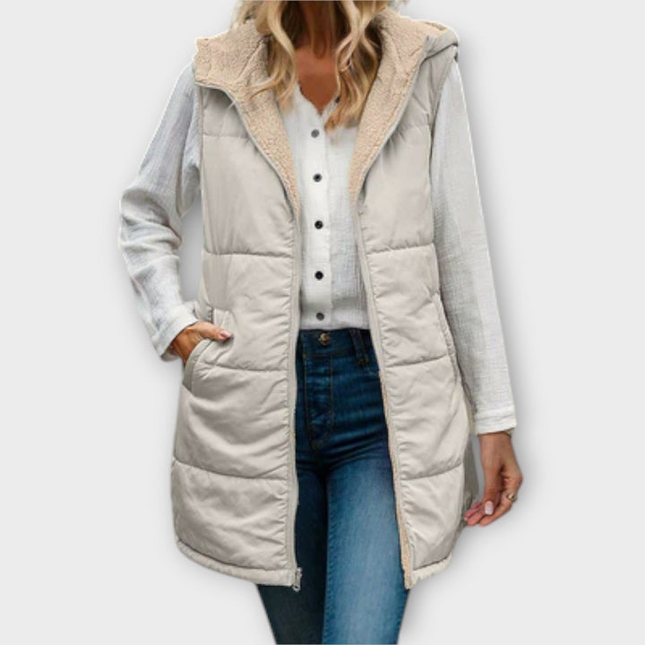 Fashionable women's red insulated puffer vest designed for warmth and layering in cold weather, fleece lined.