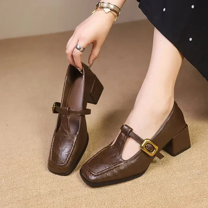 Women's black leather block heel Mary Janes with square toe and elegant T-strap, vintage style.