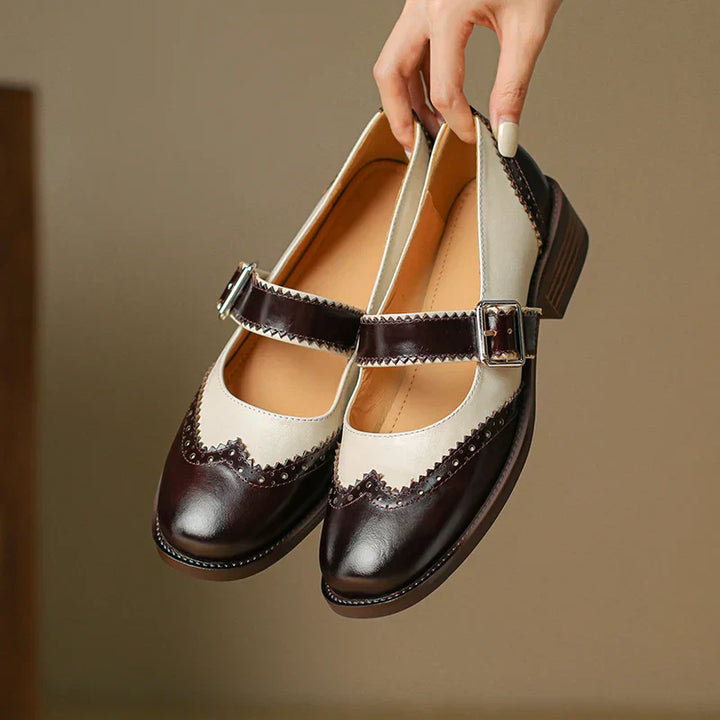 Close-up of women's casual leather Mary Jane shoe detailing the adjustable strap and comfortable flat sole.