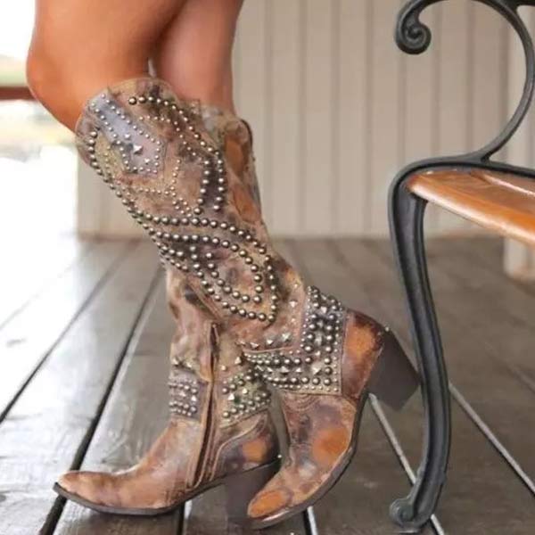 Stylish women's knee-high western boots featuring silver studs, comfortable block heel, and pointed toe for casual wear
