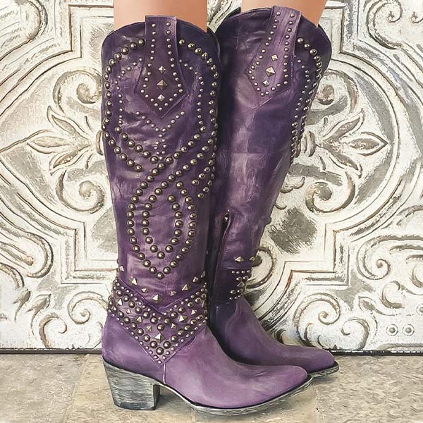Black knee-high western boots for women, adorned with studs, block heel, and pointed toe, ideal for winter outfits