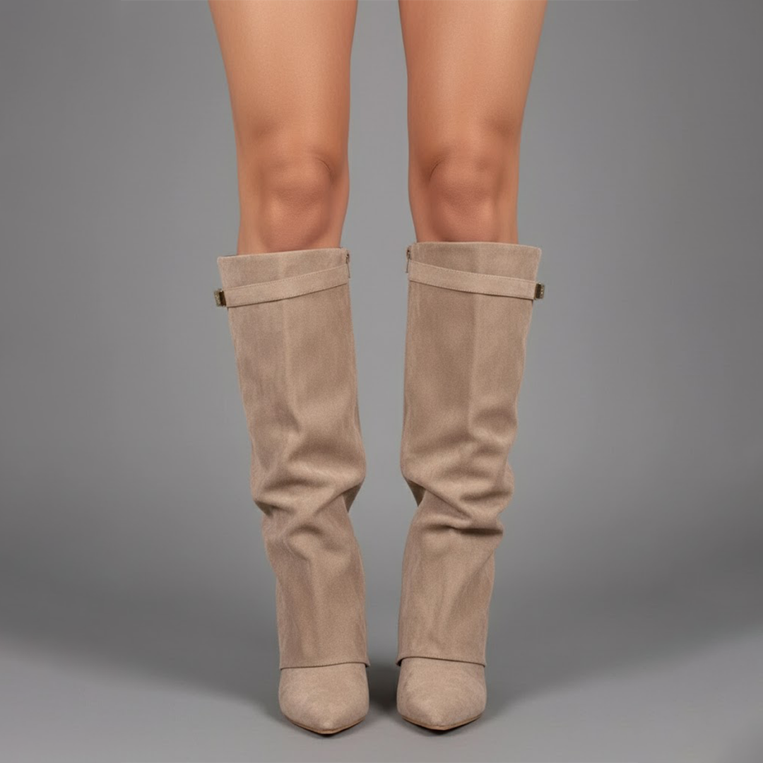 Pair of women's fashion thigh-high boots in black leather with intricate buckle accents.