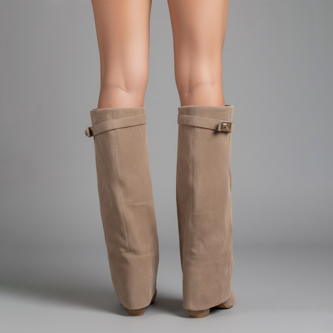 View of the back of women's black leather thigh-high boots, showcasing ankle buckle.