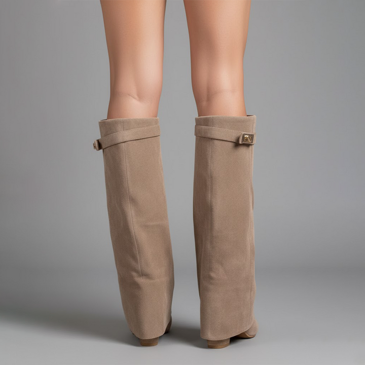 View of the back of women's black leather thigh-high boots, showcasing ankle buckle.