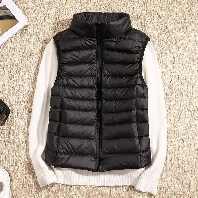 Women's black lightweight packable puffer vest, ideal for autumn layering.