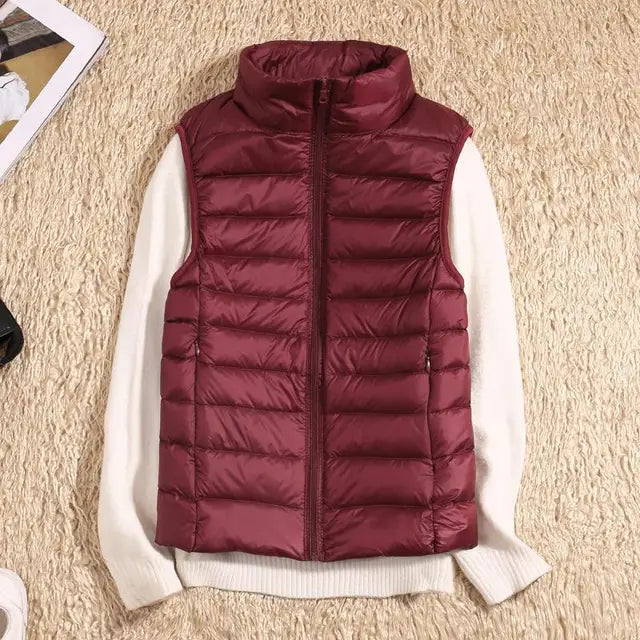 Women's khaki packable puffer vest, an essential layering piece for outdoor enthusiasts.