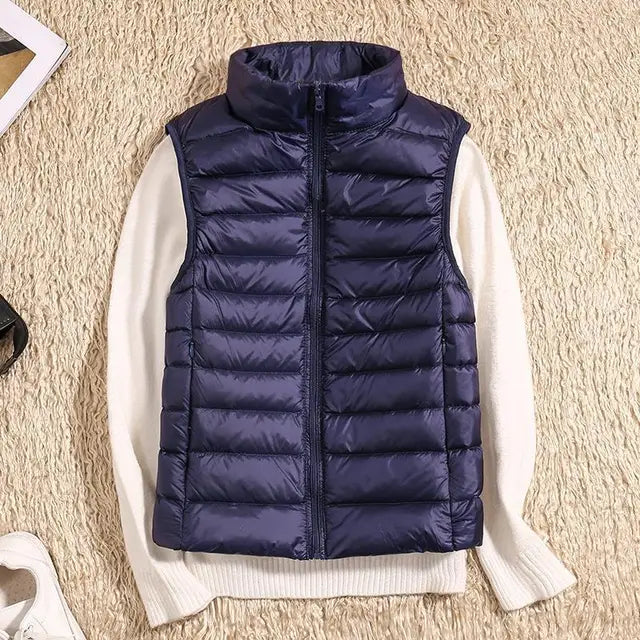 Stylish woman in a purple lightweight packable puffer vest enjoying a brisk autumn day.