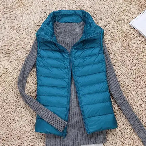 New women's puffer vest in navy, a versatile and packable outerwear piece for winter fashion.