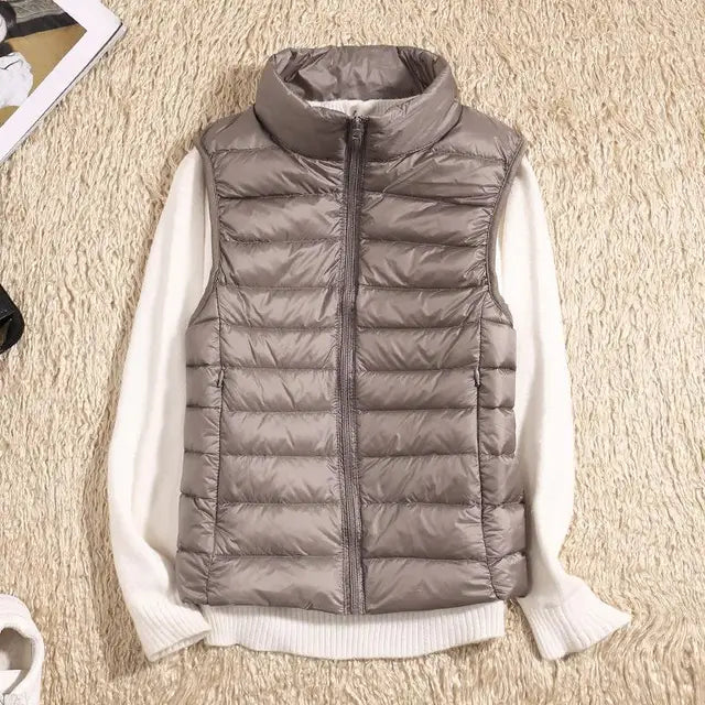 Women's packable puffer vest in white, a chic sleeveless jacket for autumn clothing.