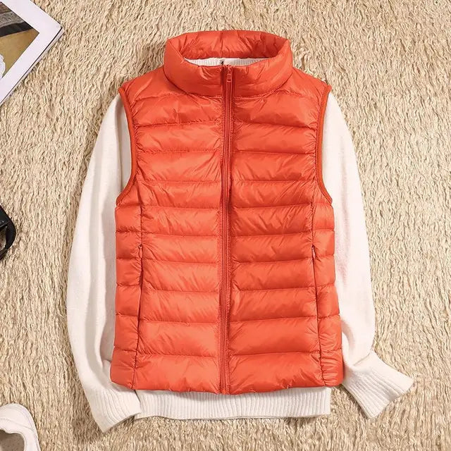 Folded women's packable puffer vest demonstrating its compact size, essential for travel.