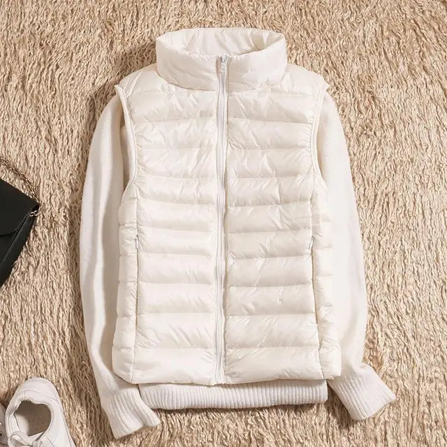 Back view of a women's functional lightweight puffer vest, emphasizing its tailored fit.