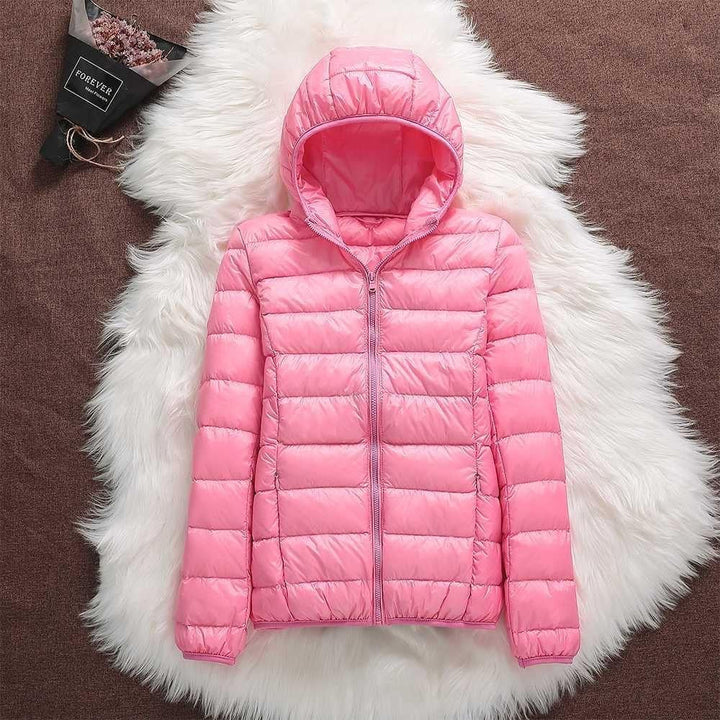 Front pocket detail on a women's waterproof puffer jacket, practical for outdoor wear.