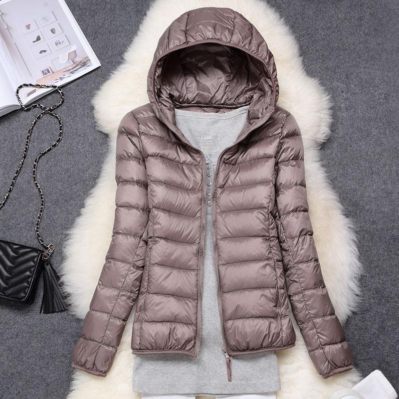 Stylish women's puffer jacket in navy, offering warmth and waterproof protection for cold weather.