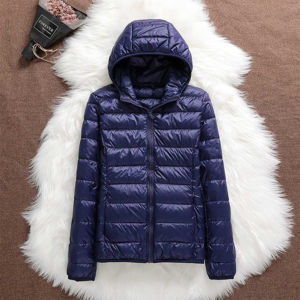 Closeup of a woman wearing a waterproof down jacket, showcasing its sleek design and warmth.