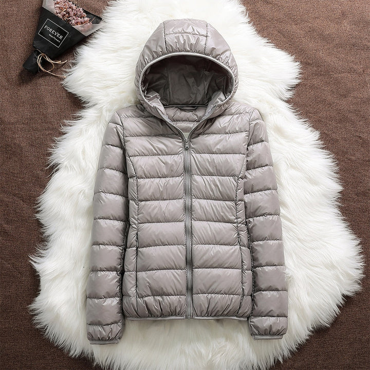Folded lightweight down jacket, demonstrating its packability for travel and convenience.