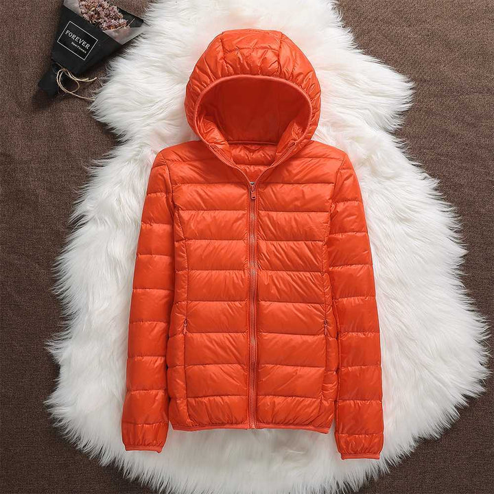 Detail of the zipper and collar on a women's lightweight down jacket, emphasizing quality.