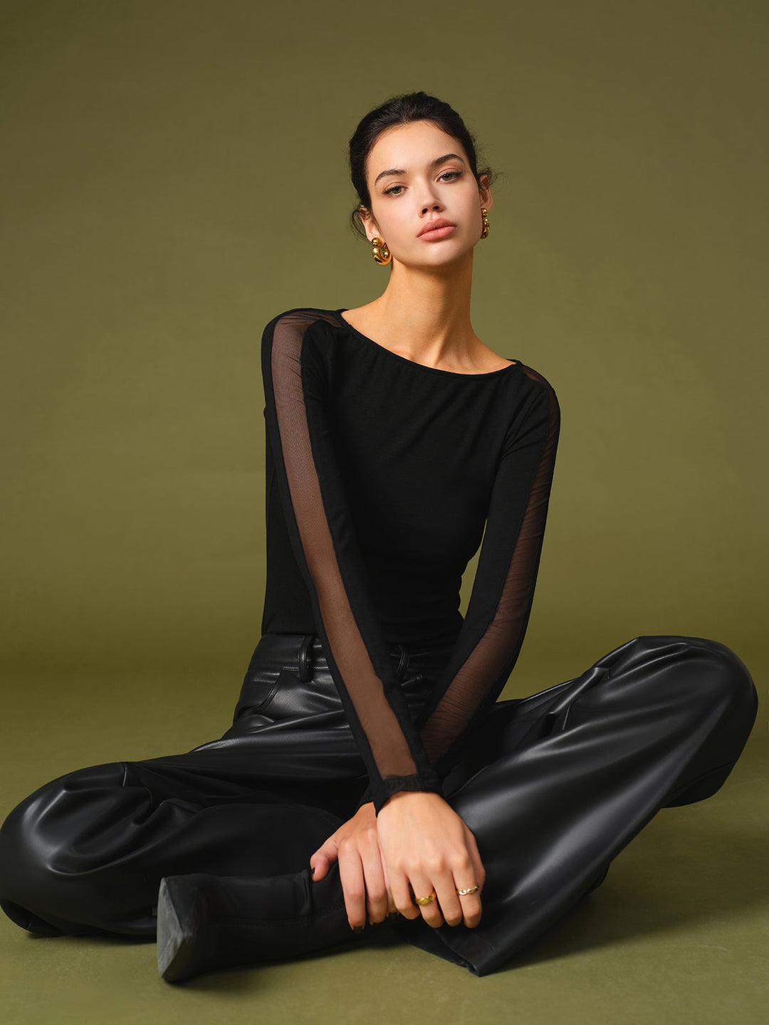 Versatile women's black mesh sleeve top, a breathable and stylish option for casual apparel.