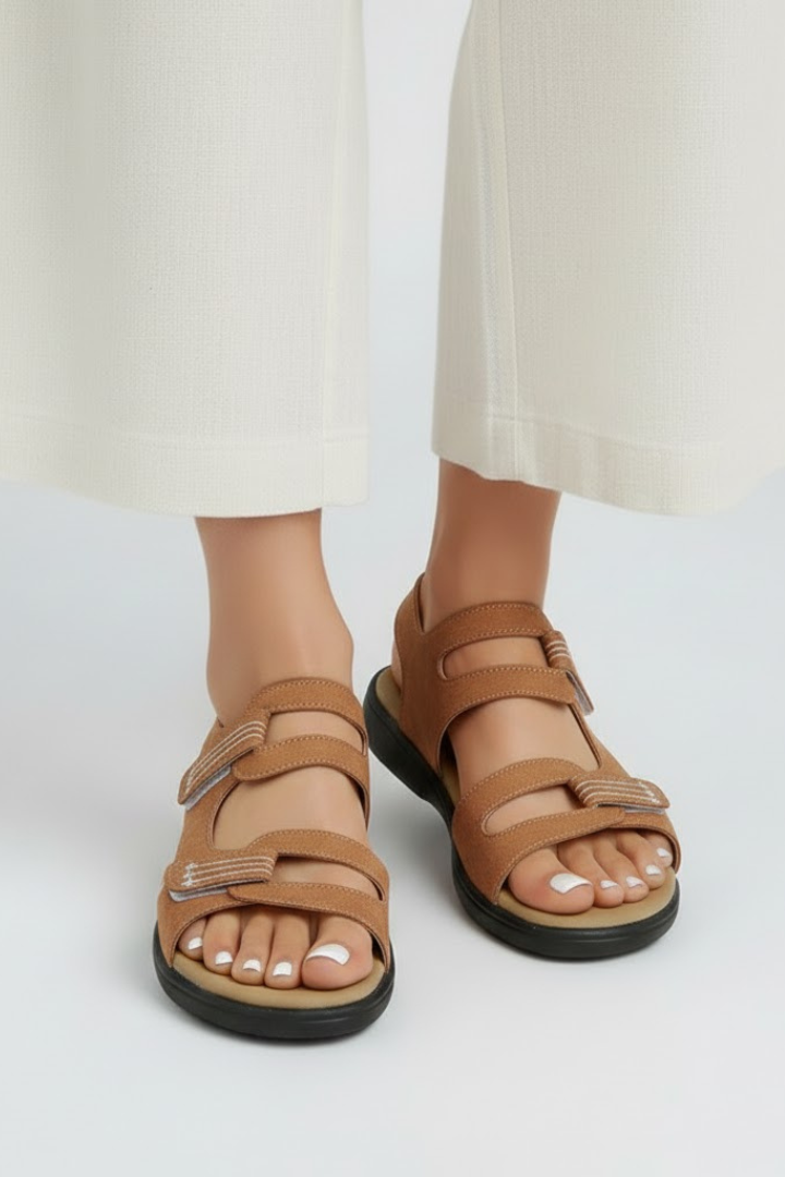 Model wearing women's multi-strap heeled sandals with a dress, fashionable summer look