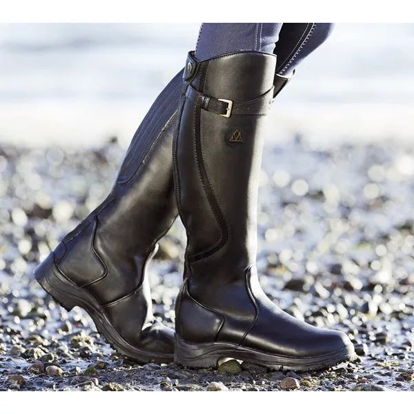 Full view of women's tall black leather riding boots with orthopedic support, fashionable footwear