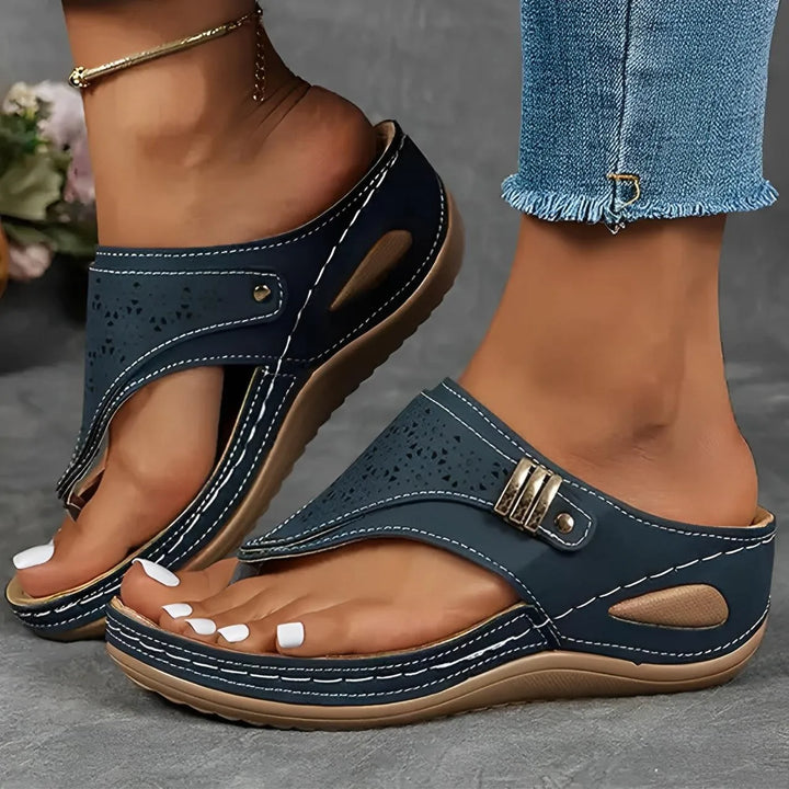 Pair of women's platform comfort sandals for summer, black with unique cut-out design closeup.