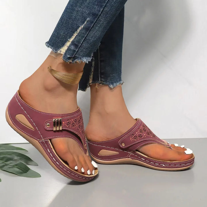 Stylish women's platform comfort sandals, black synthetic with detailed cut-out patterns, top view.