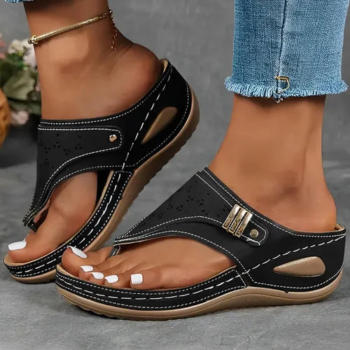 Close-up of the synthetic upper and cut-out design on women's black platform comfort sandals.