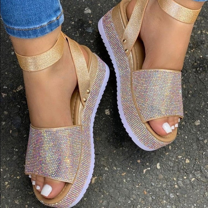 Women's black platform sandals with shimmering rhinestone straps, perfect for evening wear and summer fashion.